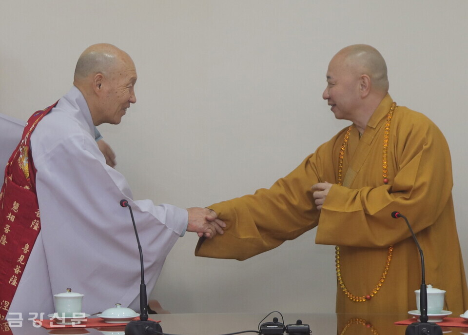 총무원장 덕수 스님과 중국불교협회 부회장 밍셩 스님이 악수로 인사하고 있다.
