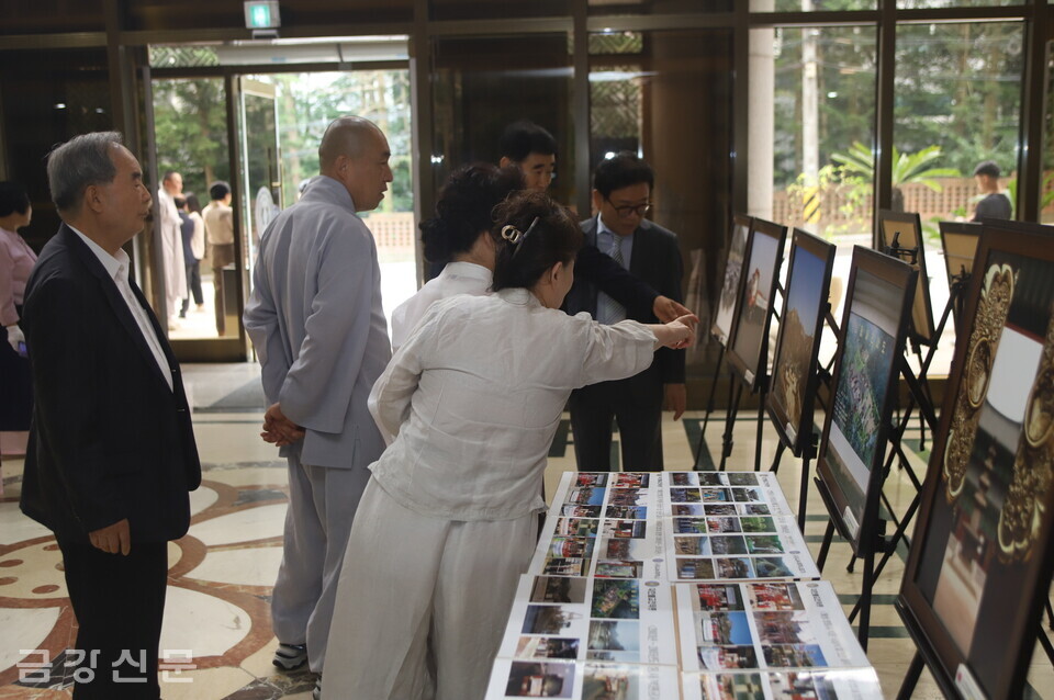 관문사 재무 도각 스님과 신도들이 천태종의 남북종교교류 관련 사진전을 둘러보고 있다.